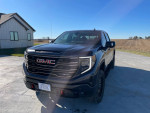 2022 GMC Sierra 1500 AT4X 4WD in a rural setting, showcasing its robust design and features.