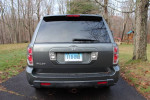 Rear view of a 2007 Honda Pilot EX-L in good condition with 63,000 miles, parked in a yard.