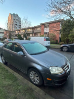 2006 Volkswagen Jetta on the street, showing excellent condition with updated features and a sleek design.