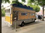1997 Chevy P30 catering food truck with aluminum body and multiple menu boards parked on a street in Los Angeles.