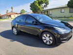 2021 Tesla Model Y Long Range Performance, sleek black design, parked on a residential street.