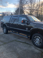2012 Ford F350 Super Duty diesel truck with black leather interior and aftermarket features