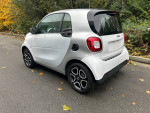 2016 Smart Fortwo Pure in silver, parked with autumn leaves, featuring 15-inch aluminum wheels and a clean exterior.