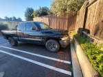 1998 Dodge Ram 1500 truck with 160k miles parked in Lompoc, California, showing visible scratches.
