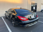 2012 Mercedes-Benz CLS550 in black with no dents, parked, showcasing sleek design and luxurious features.