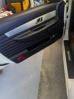 Interior door of a 2003 Thunderbird Hardtop Convertible, showcasing controls and clean design.