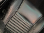 Close-up of the black leather seat in a 2003 Thunderbird Hardtop Convertible, showcasing its clean and well-maintained design.