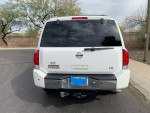 Rear view of a 2004 Nissan Armada LE 4WD in white, showcasing its design and condition.