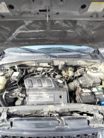 Engine compartment of a 2002 Ford Escape 4x4 showing maintenance details and components.