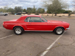 1968 red Ford Mustang for sale, featuring automatic transmission and newer wheels, parked outdoors.