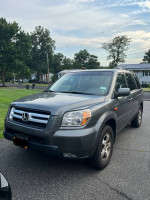 2007 Honda Pilot EX-L gray SUV parked on the street with 169,000 miles, in fair condition with navigation features.