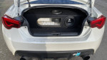 View of the trunk showcasing the custom audio setup in a 2015 Subaru BRZ with 18" wheels.