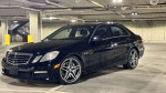 2010 Mercedes-Benz E63 AMG in a parking lot, showcasing its sleek design and alloy wheels.