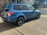 2009 Subaru Forester 2.5X AWD in blue, parked outside with clean exterior and modern design features.
