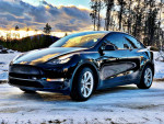 2021 Tesla Model Y in excellent condition, featuring all-wheel drive, premium interior, and scenic snowy backdrop