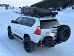 2010 Lexus GX 460 4WD with off-road modifications parked in snowy landscape