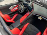 Interior view of 2022 Chevrolet Corvette Stingray with red leather seats and modern dashboard.
