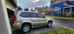2004 Lexus GX 470 SUV parked in a residential area, featuring clean lines and a polished exterior.