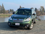 2013 Subaru Outback parked by a river, featuring new tires and a replaced transmission, in good condition