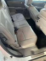 Interior view of the 2014 Honda Pilot EX with leather seats and spacious 3rd row seating.