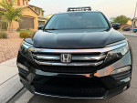 Front view of a 2017 Honda Pilot Elite AWD with 105,000 miles, showcasing its sleek design and good condition.