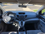 Interior view of a clean 2014 Honda CR-V LX with automatic transmission and modern dashboard features.