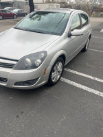 2008 Saturn Astra XE FWD hatchback in silver, low miles, parked with trees in background.