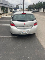 Rear view of a 2008 Saturn Astra XE hatchback in silver, parked in a lot, showcasing its design and low mileage.