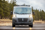 Front view of a 2017 Ram 1500 Promaster van with rugged features, parked in a forested area in Flagstaff, AZ.