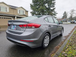 2017 Hyundai Elantra with 126,000 miles, clean title, parked on a rainy street.