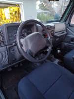 Interior view of a 1999 Jeep Wrangler featuring clean dashboard and upholstery.