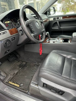 Interior view of a 2010 Volkswagen Touareg showing dashboard, leather seats, and modern features.