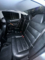 Interior view of a 2002 Volkswagen Passat GLX with black leather seats, suitable for families and daily driving.