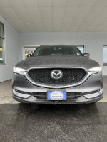 Front view of a 2019 Mazda CX-5 Signature with 28K miles on display at a dealership