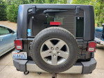 Rear view of a 2010 Jeep Wrangler Mountain Edition with a clean title and 142,000 miles for sale.