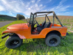 1972 Jeep CJ5 with new parts and custom suspension parked in a scenic vineyard