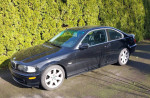 2002 BMW 325ci Coupe parked in a lush green environment, well-maintained with low mileage.
