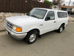 1995 Ford Ranger regular cab, white, in excellent condition with low mileage and clean title, parked on the street