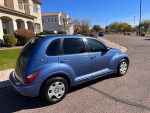 2006 Chrysler PT Cruiser Touring edition parked on a residential street with clear blue sky
