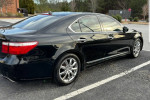 2008 Lexus LS 460 in black with chrome rims parked, showcasing sleek design and elegance.