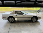 1990 Chevrolet Corvette convertible with a new top and custom exhaust parked on a driveway