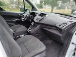 Interior view of a 2018 Ford Transit Connect Cargo Van XL with front seats and dashboard.