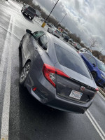 2016 Honda Civic EX FWD parked in a lot, showcasing sleek design and clean exterior.