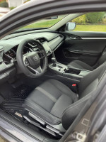 Interior view of a 2016 Honda Civic EX with black seats and modern dashboard design