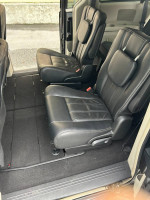 Interior view of 2016 Dodge Grand Caravan with leather-faced seating, showcasing spacious rear seating area.