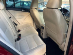 Interior view of 2014 Volkswagen Tiguan SEL with beige leather seats and spacious rear passenger area.