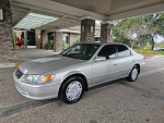 2000 Toyota Camry LE FWD with low miles, silver color, parked near a building, ready for sale.