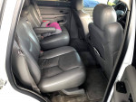Interior view of a 2005 Chevrolet Tahoe showing comfortable leather seats and spacious back seating area.