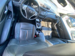Interior view of a 2014 Nissan Rogue SL with leather seats, dashboard, and controls.