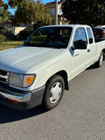 White 1995 Toyota Tacoma SR5 pickup truck with new tires, clean title, and good condition, parked on the street.